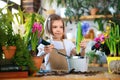 Child planting spring flowers. Little girl gardener plants hyacinth. Girl holding hyacinth in flower pot. Child taking Royalty Free Stock Photo