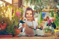 Child planting spring flowers. Little girl gardener plants hyacinth. Girl holding hyacinth in flower pot. Child taking Royalty Free Stock Photo