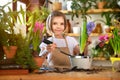 Child planting spring flowers. Little girl gardener plants hyacinth. Girl holding hyacinth in flower pot. Child taking Royalty Free Stock Photo