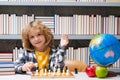 Child play chess in classroom at school. Kid thinking about chess. The concept of learning and growing children. Chess Royalty Free Stock Photo