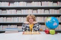 Child play chess. Chess for intelligent kid. Child genius, smart pupil playing logic board game. Clever school boy Royalty Free Stock Photo