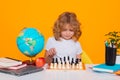 Child play chess on isolated background. Chess for intelligent kid. Child genius, smart pupil playing logic board game Royalty Free Stock Photo