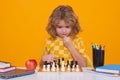 Child play chess on studio background. Kid thinking about chess. The concept of learning and growing children. Chess Royalty Free Stock Photo