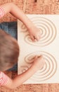 Child play with double-sided Interhemispheric board on floor