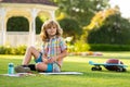 Child play and draw craft artwork homework. School kid drawing in summer park, painting art. Little painter draw Royalty Free Stock Photo