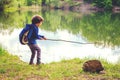 Child play fishing near lake. Royalty Free Stock Photo