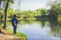 Child play fishing near lake. Royalty Free Stock Photo