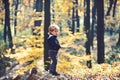 Child play on fresh air outdoor. Small boy play in autumn forest. Autumn vacation and camping. Little prince in fairy Royalty Free Stock Photo