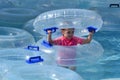 Child play with Inflatable clear inner tubes Royalty Free Stock Photo