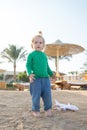 Child play on sand beach. Small boy with plane toy outdoor. Kid have fun on summer vacation. Imagination, freedom and dream concep Royalty Free Stock Photo