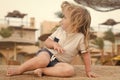 Child play on sand. Small boy sit on tropical beach. Summer activity on beach. Vacation, leisure and relax concept. Kid Royalty Free Stock Photo