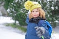 Child play with snow in winter park. Kids with first snow. Child winter holiday. Smiling boy playing with snow in winter Royalty Free Stock Photo