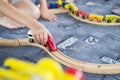 Child play with wooden train, build toy railroad at home or kindergarten. Toddler kid play with wooden train Royalty Free Stock Photo