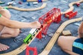 Child play with wooden train, build toy railroad at home or kindergarten. Toddler kid play with wooden train Royalty Free Stock Photo