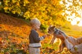 Child play with yorkshire terrier dog. Toddler boy enjoy autumn with dog friend. Small baby toddler on sunny autumn day Royalty Free Stock Photo