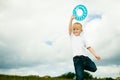 Child in playground kid in action boy playing with frisbee Royalty Free Stock Photo