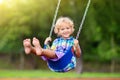 Child on playground. swing Kids play outdoor Royalty Free Stock Photo