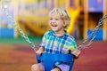 Child on playground. swing Kids play outdoor Royalty Free Stock Photo