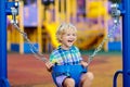 Child on playground. swing Kids play outdoor Royalty Free Stock Photo