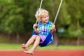 Child on playground. swing Kids play outdoor Royalty Free Stock Photo