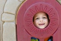 Child in playhouse window Royalty Free Stock Photo