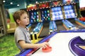 Child playing air hockey