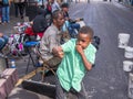 Child Playing Air Trombone with Buskers on Royal Street in the French Quarter Royalty Free Stock Photo
