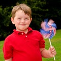 Child playing with American flag pinwheel Royalty Free Stock Photo