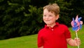 Child playing with American flag pinwheel Royalty Free Stock Photo