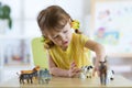 Child playing with animal toys at table in kindergarten or home Royalty Free Stock Photo