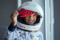 Child playing with astronaut helmet and toy rocket Royalty Free Stock Photo