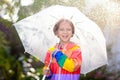 Child playing in autumn rain. Kid with umbrella Royalty Free Stock Photo