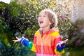 Child playing in autumn rain. Kid with umbrella Royalty Free Stock Photo