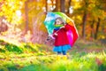 Child playing in autumn rainy park Royalty Free Stock Photo