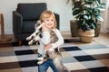 Child playing with baby cat. Kid holding black kitten. Little girl snuggling cute pet animal in sunny living room at home. Kids Royalty Free Stock Photo