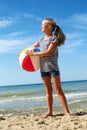 A child playing with a ball on the beach. Royalty Free Stock Photo