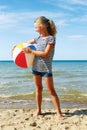 A child playing with a ball on the beach. Royalty Free Stock Photo