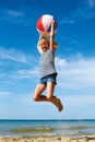 A child playing with a ball on the beach. Royalty Free Stock Photo