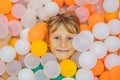 Child playing in ball pit. Colorful toys for kids. Kindergarten or preschool play room. Toddler kid at day care indoor Royalty Free Stock Photo