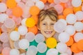 Child playing in ball pit. Colorful toys for kids. Kindergarten or preschool play room. Toddler kid at day care indoor Royalty Free Stock Photo