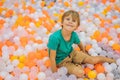 Child playing in ball pit. Colorful toys for kids. Kindergarten or preschool play room. Toddler kid at day care indoor Royalty Free Stock Photo