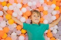 Child playing in ball pit. Colorful toys for kids. Kindergarten or preschool play room. Toddler kid at day care indoor Royalty Free Stock Photo