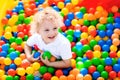 Child playing in ball pit on indoor playground Royalty Free Stock Photo