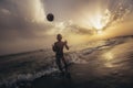 Child playing with ball during sunset. Selective focus Royalty Free Stock Photo