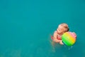 Child playing with ball. Swimming pool water activities, top view Royalty Free Stock Photo