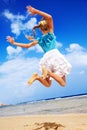 Child playing on beach aganist blue sky. Royalty Free Stock Photo