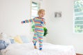 Child playing in bed. Kids room. Baby boy at home Royalty Free Stock Photo