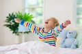 Child playing in bed. Kids room. Baby boy at home Royalty Free Stock Photo