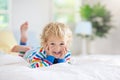 Child playing in bed. Kids room. Baby boy at home Royalty Free Stock Photo