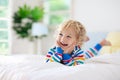 Child playing in bed. Kids room. Baby boy at home Royalty Free Stock Photo